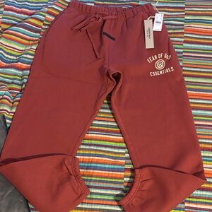 Sale today Fear of God Essentials crimson, cuffed joggers size extra small new